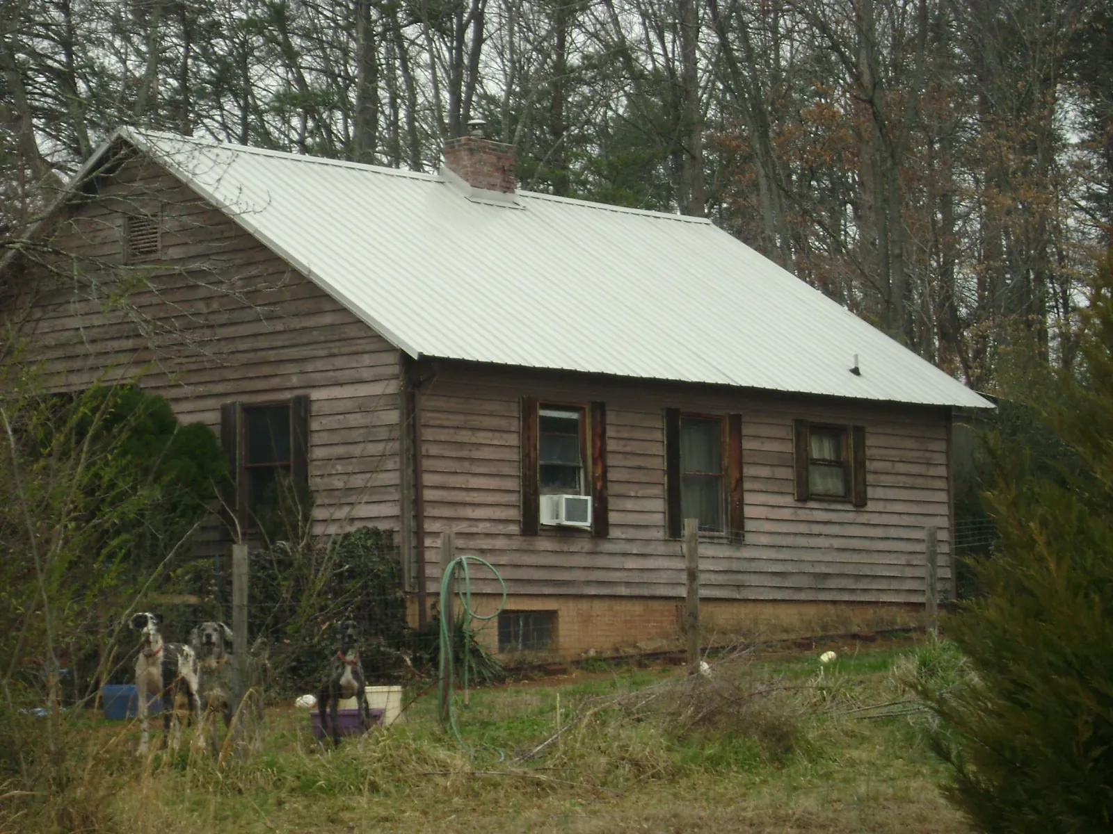 White metal roof on an old wood sided farmhouse, from a Metal Roof Installation job in Bascom